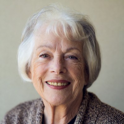 Elderly woman smiling with white hair
