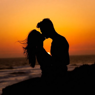 Silhouette couple kissing at sunset beach