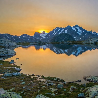 Sunset over Alpine Lake and Mountains
