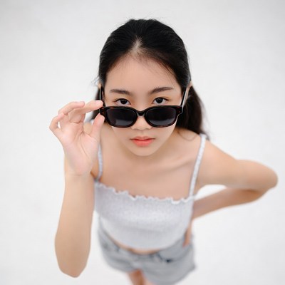 Asian girl holding sunglasses