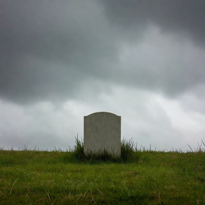 Blank gravestone in grassy field