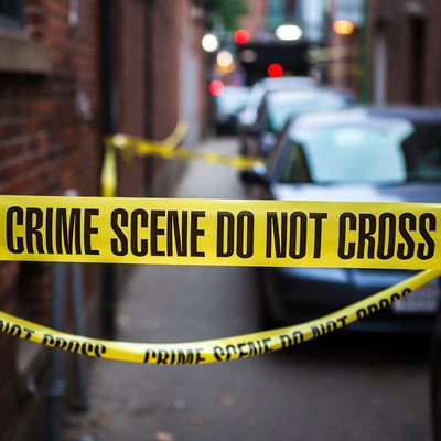 Crime Scene Tape on Narrow Street