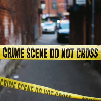 Crime Scene Tape in Urban Alley