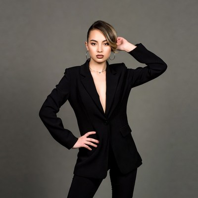 Asian woman in black blazer posing