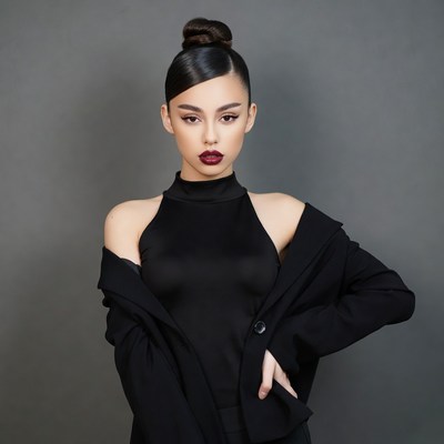 Asian woman in black dress and jacket