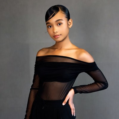 Young Black woman in sheer black off-shoulder top