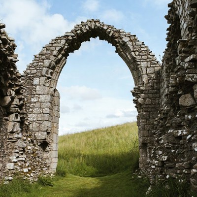 Ruined Stone Archway in Green Field