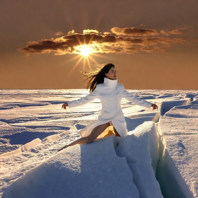 Woman in white coat on ice field sunset