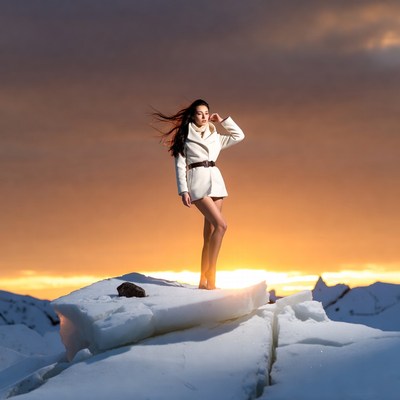 Woman in white coat on ice sunset