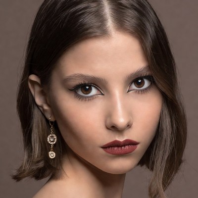 Woman with bob haircut and gold earrings