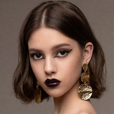 Woman with bob haircut and gold earrings