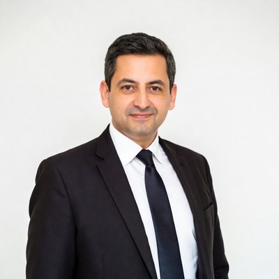 Man in black suit smiling