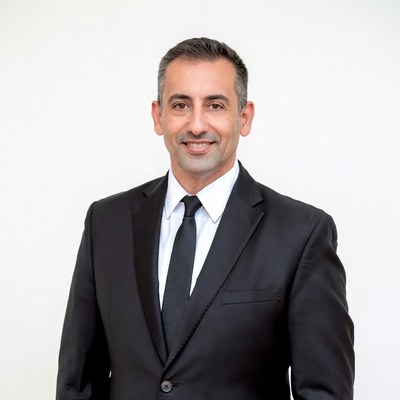 Man in black suit smiling