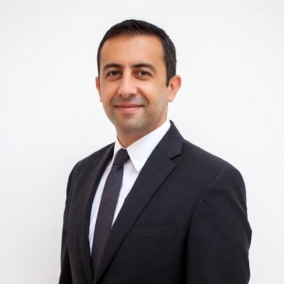 Man in black suit smiling