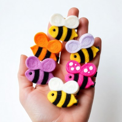 Hand holding colorful felt bee hair clips