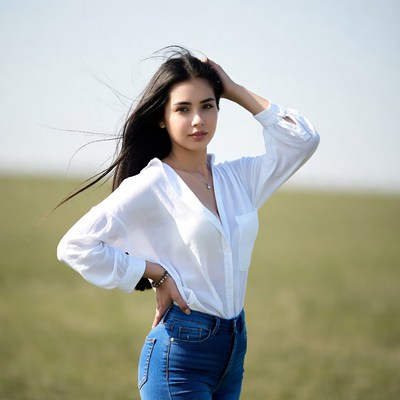 Woman with long hair in white blouse field