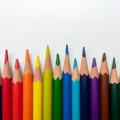 Rainbow colored pencils on white