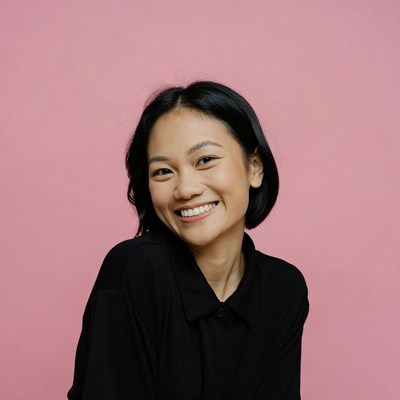 Asian woman smiling on pink background