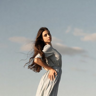 Woman in gray dress with flowing hair