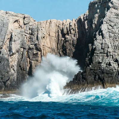 Ocean Waves Crashing Against Rocky Cliffs