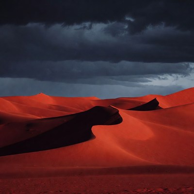 Red Sand Dunes Under Dark Storm Clouds