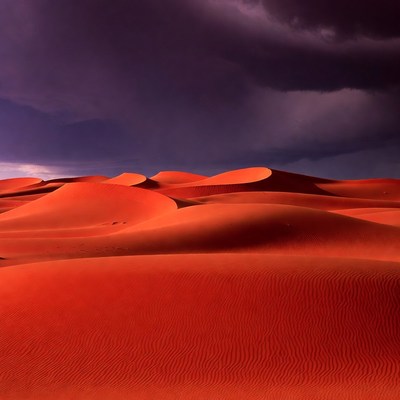 Red Sand Dunes Under Stormy Sky