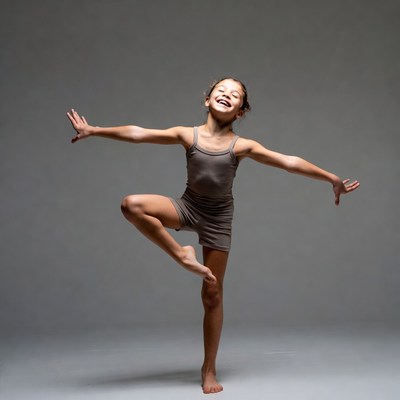 Young girl dancing with arms outstretched