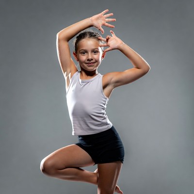 Young girl posing in dance stance