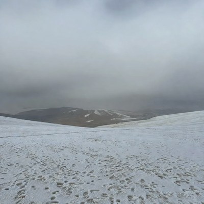 Snowy Mountain Valley with Footprints