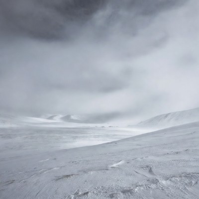 Snowy Mountain Landscape Under Cloudy Sky