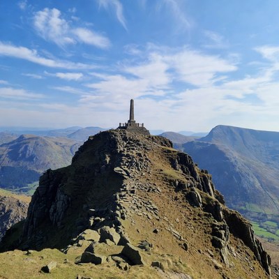 Obelisk atop rocky mountain peak
