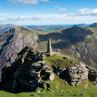 Obelisk atop rocky mountain ridge