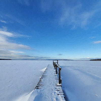 Wooden pier on frozen lake