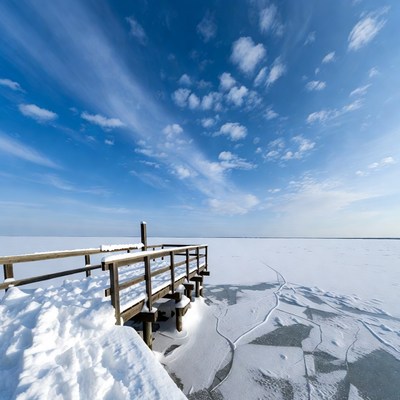 Wooden pier on frozen lake