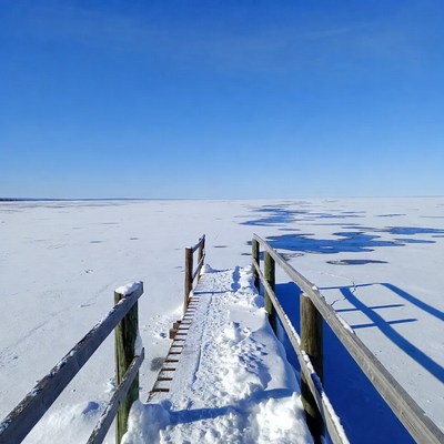 Wooden pier over frozen lake