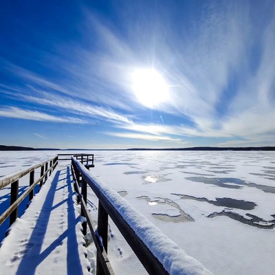 Wooden pier over frozen lake