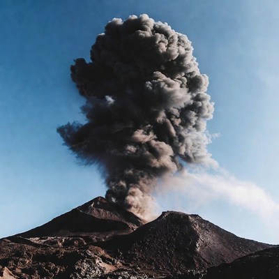 Volcano erupting with ash plume