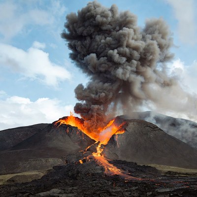 Volcano erupting with lava and ash plume