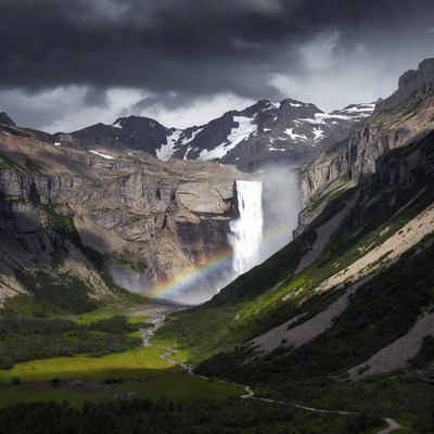 Waterfall with Rainbow in Mountains