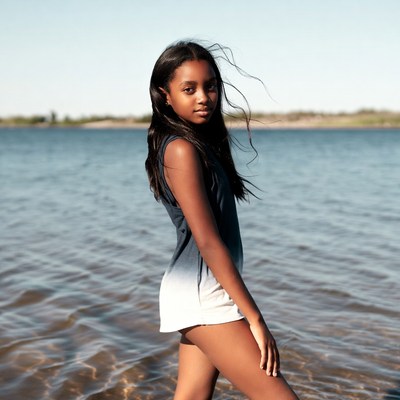 African-American girl standing in lake water