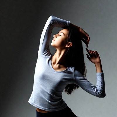Woman in gray top striking dance pose