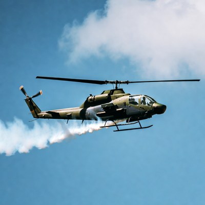 Military helicopter flying with smoke trail