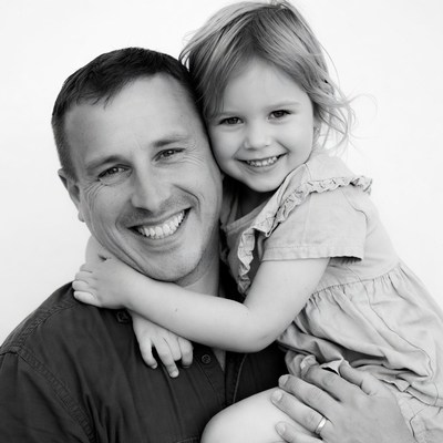Smiling father holding daughter
