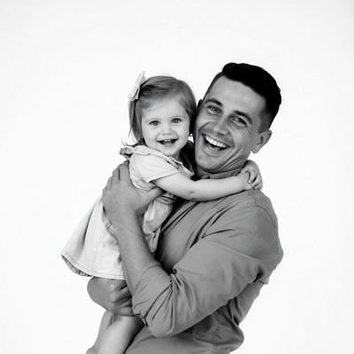 Father holding smiling baby girl