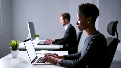 African-American woman and man working on laptops