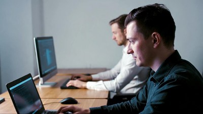 Two men working on computers
