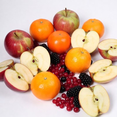 Assortment of sliced apples oranges berries