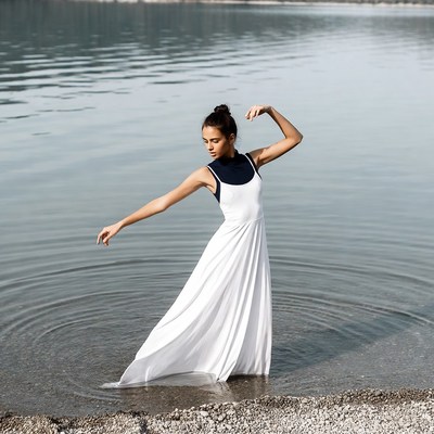 Woman dancing in white dress lake
