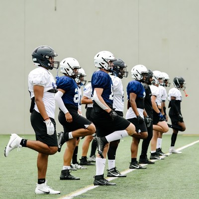 Football players stretching on field