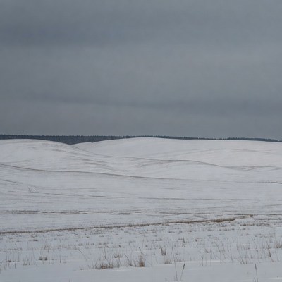 Snowy Hills Under Gray Sky